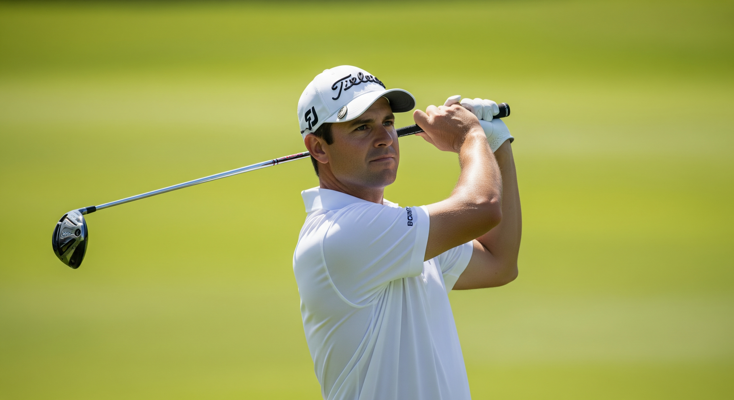 Adult golfer holding a balanced follow-through after a full swing on the course.
